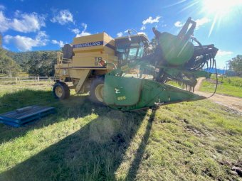 New Holland TR97 Harvester with John Deere 24ft Stainless Front