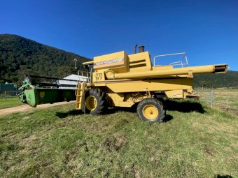 New Holland TR97 Harvester with John Deere 24ft Stainless Front