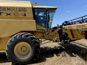 1997 New Holland TX 64 Header with 25ft Honeybee Front