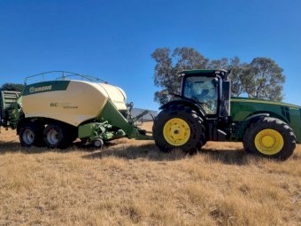 2015 John Deere 8295R Tractor with a 2017 Krone 1290 Big Pack Baler
