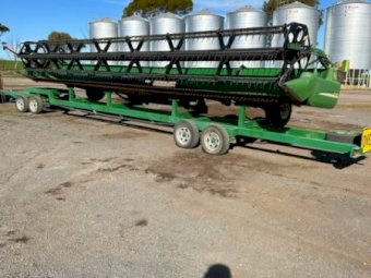 2002 John Deere 9750 STS header with 936D front and trailer.