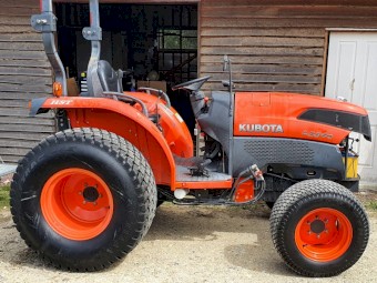 Set of used turf tyres and rims from a Kubota L3540