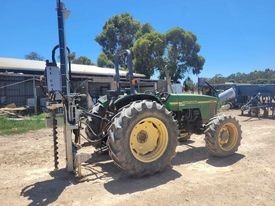 5410 John Deere tractor with Elgra 50 post driver