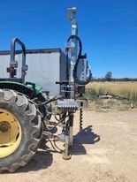 5410 John Deere tractor with Elgra 50 post driver