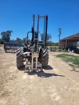 5410 John Deere tractor with Elgra 50 post driver