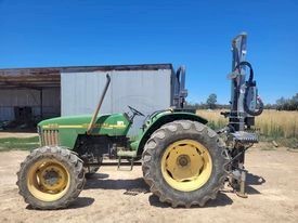 5410 John Deere tractor with Elgra 50 post driver
