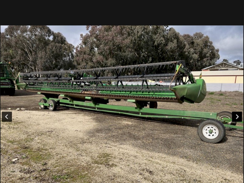 2012 John Deere 640D Front with x-auger and trailer