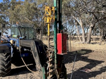 Munro post driver with manitou quick hitch.