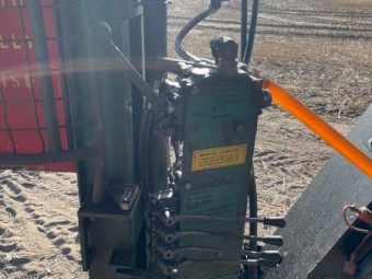 Munro post driver with manitou quick hitch.