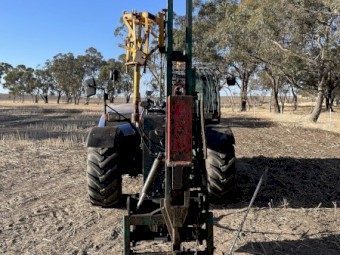 Munro post driver with manitou quick hitch.